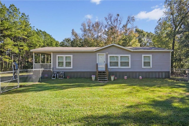 rear view of property featuring a lawn