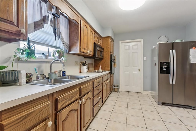 kitchen with stainless steel fridge with ice dispenser, light tile patterned floors, and sink