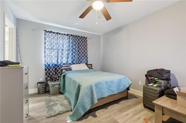 bedroom with light hardwood / wood-style floors and ceiling fan