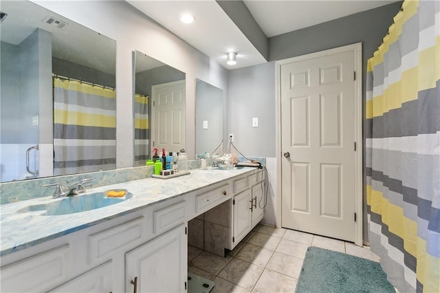 bathroom with tile patterned floors and vanity