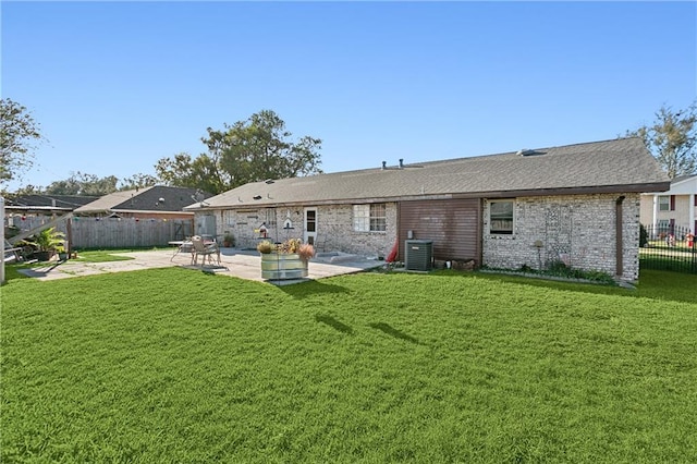 back of property with a patio, cooling unit, and a lawn