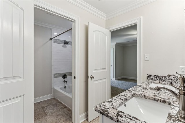 bathroom featuring ornamental molding, shower / bathtub combination, and vanity