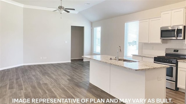 kitchen with white cabinets, a center island with sink, sink, vaulted ceiling, and stainless steel appliances