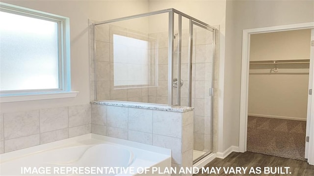 bathroom with independent shower and bath and hardwood / wood-style flooring