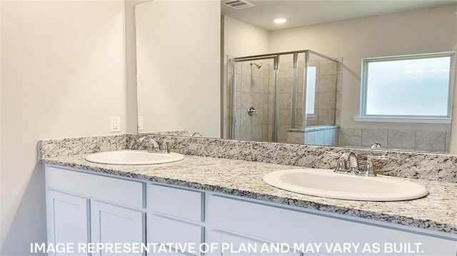 bathroom featuring vanity and a shower with shower door