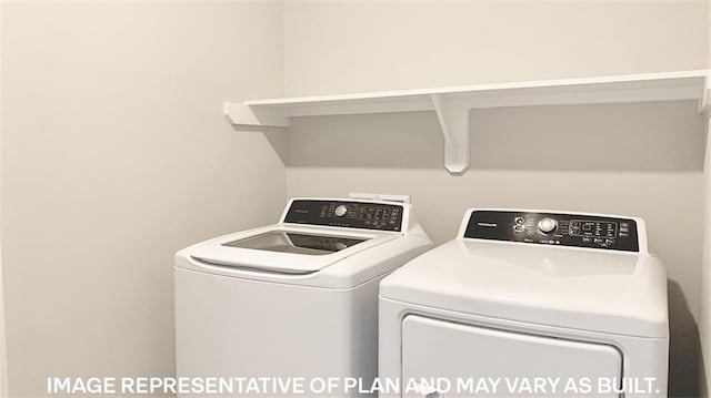 clothes washing area featuring separate washer and dryer