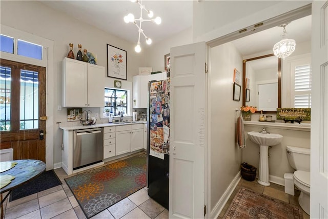 kitchen with dishwasher, white cabinets, hanging light fixtures, and sink