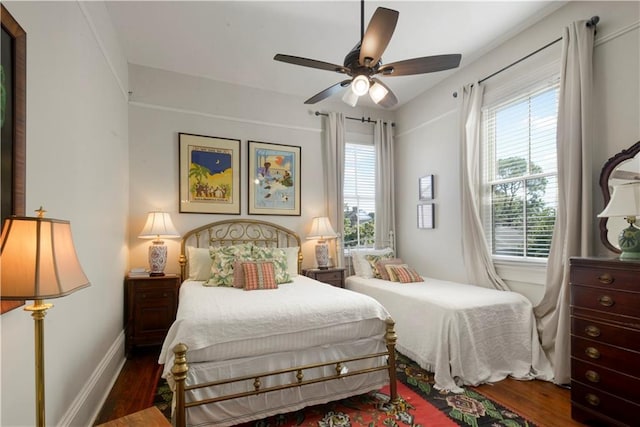 bedroom with ceiling fan and dark hardwood / wood-style floors