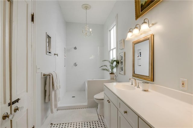 bathroom featuring vanity, tiled shower, a notable chandelier, tile patterned flooring, and toilet