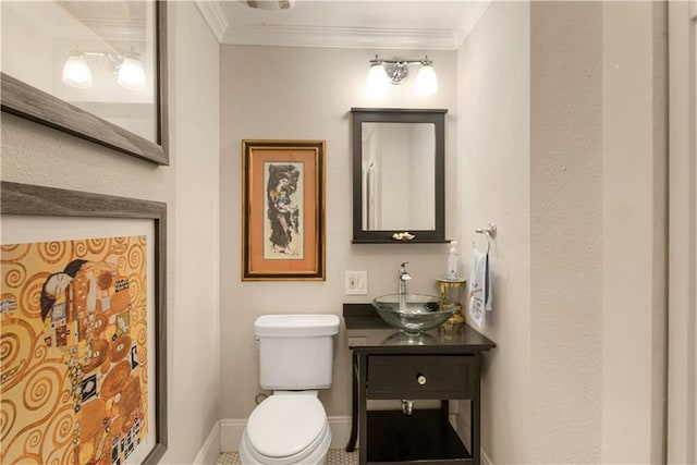 bathroom featuring vanity, toilet, and crown molding