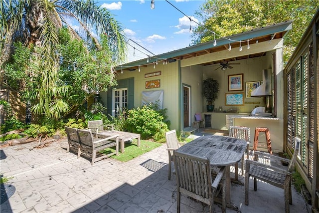 view of patio / terrace with ceiling fan and exterior kitchen