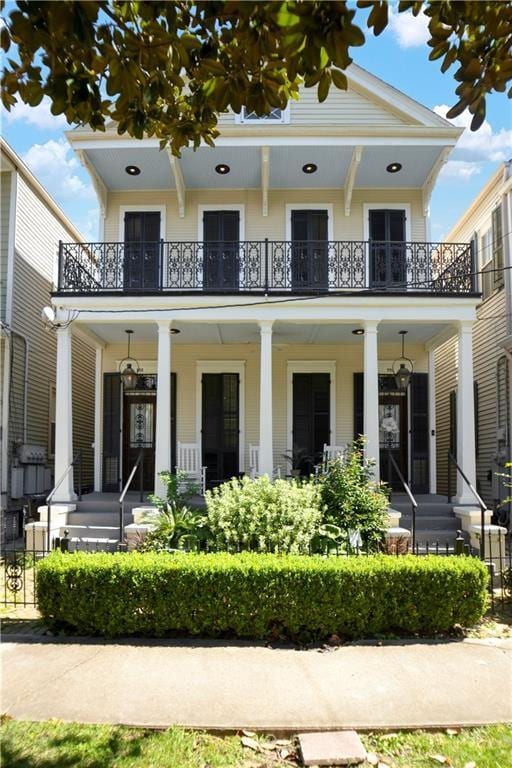 view of front of home with a balcony and covered porch