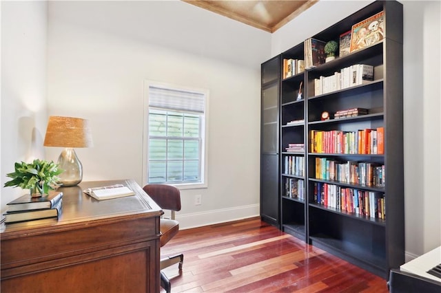 home office with crown molding and hardwood / wood-style floors