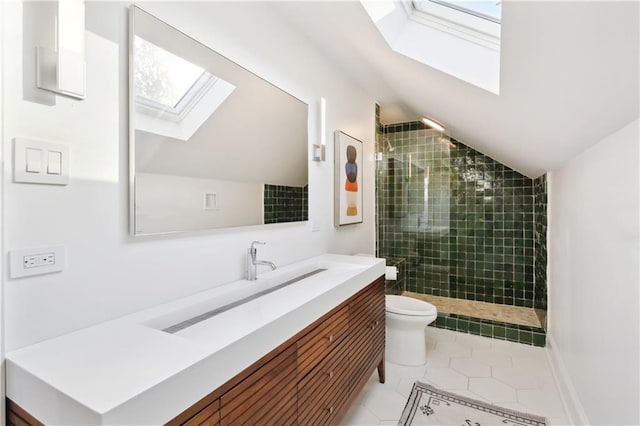 bathroom with tile patterned flooring, lofted ceiling with skylight, a healthy amount of sunlight, and toilet