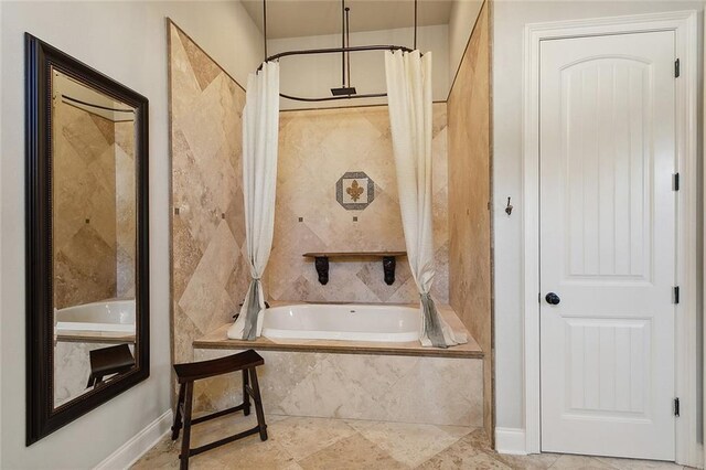 bedroom with a tray ceiling, light colored carpet, and ceiling fan