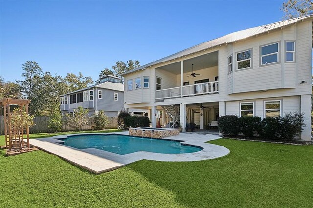 view of pool with an in ground hot tub, a patio, and a lawn