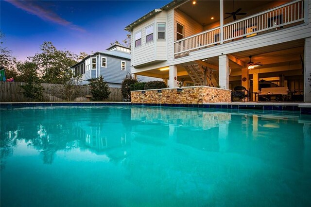 view of swimming pool with pool water feature and ceiling fan