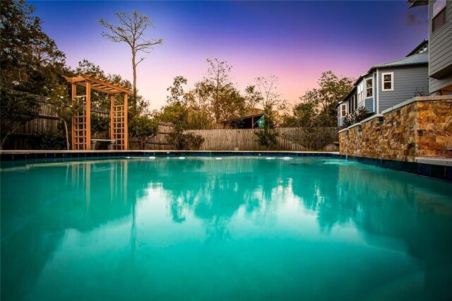 view of pool at dusk