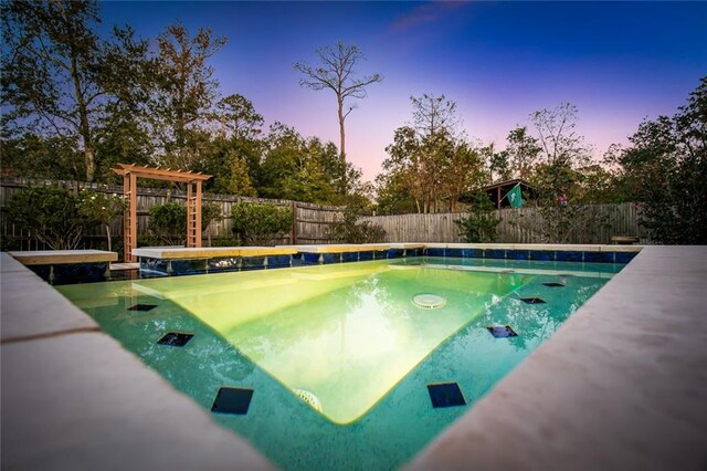 view of pool at dusk