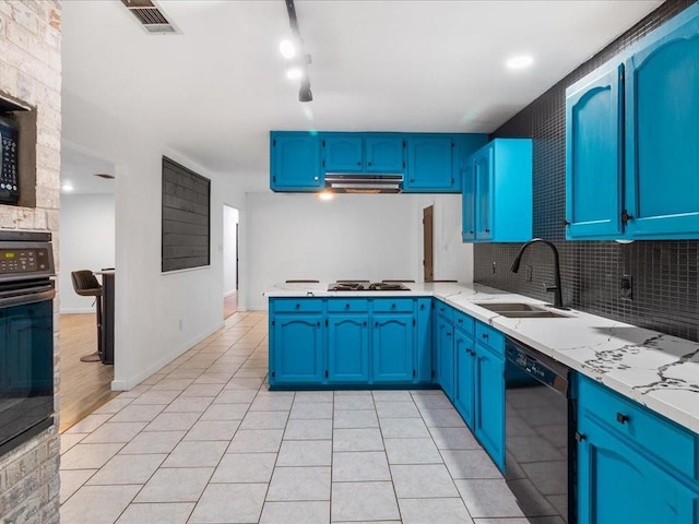 kitchen with blue cabinetry, sink, and black appliances