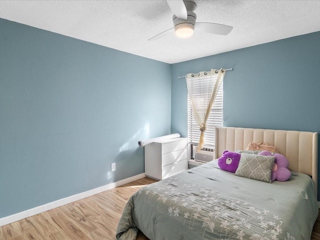 bedroom featuring wood-type flooring, a textured ceiling, and ceiling fan