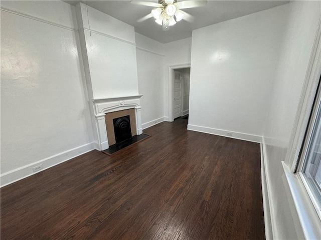 unfurnished living room with ceiling fan and dark hardwood / wood-style flooring