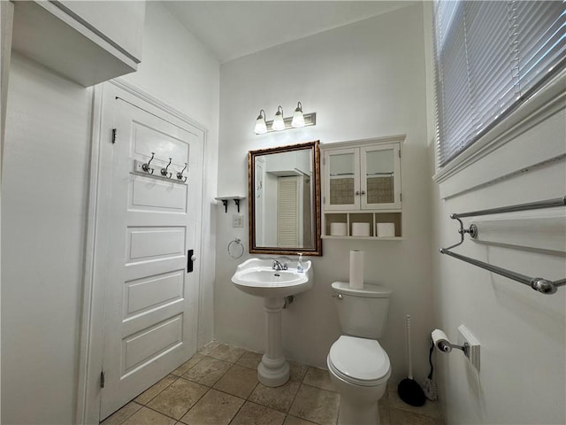 bathroom featuring sink, tile patterned flooring, and toilet