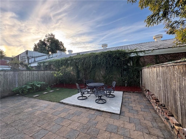 view of patio terrace at dusk