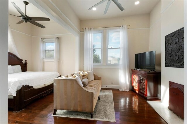 bedroom featuring ceiling fan and dark wood-type flooring