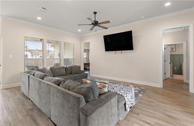 living room featuring light hardwood / wood-style flooring, ceiling fan, and crown molding