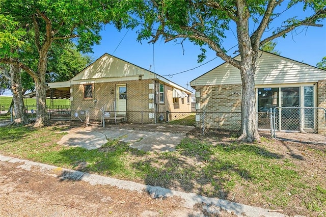 back of house featuring a carport