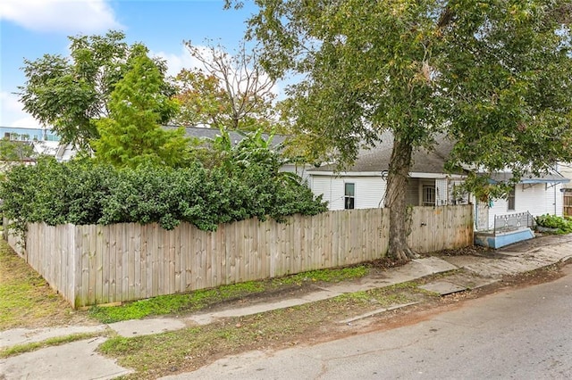 view of side of home featuring a fenced front yard