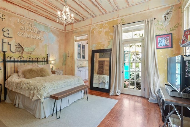 bedroom featuring a chandelier and hardwood / wood-style floors