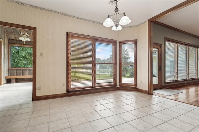 unfurnished dining area featuring a notable chandelier, light tile patterned flooring, and a wealth of natural light