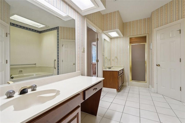 bathroom featuring tile patterned flooring, vanity, and shower with separate bathtub