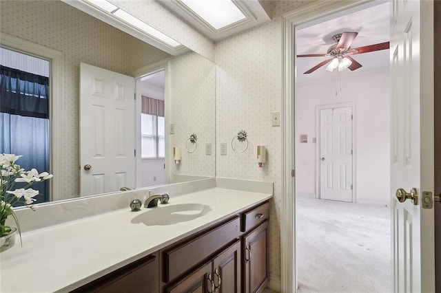 bathroom featuring ceiling fan and vanity