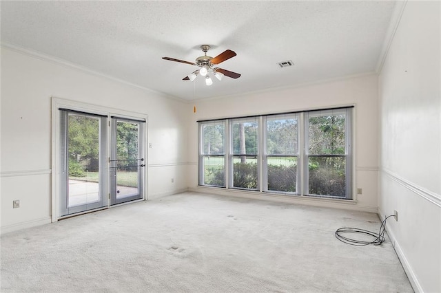 carpeted empty room featuring crown molding and ceiling fan