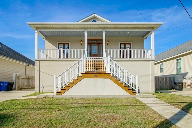 view of front of house with covered porch and a front lawn