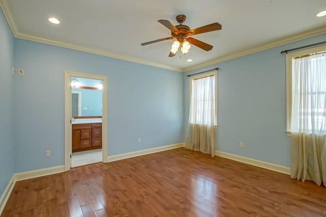 unfurnished bedroom with wood-type flooring, ensuite bath, ceiling fan, and crown molding