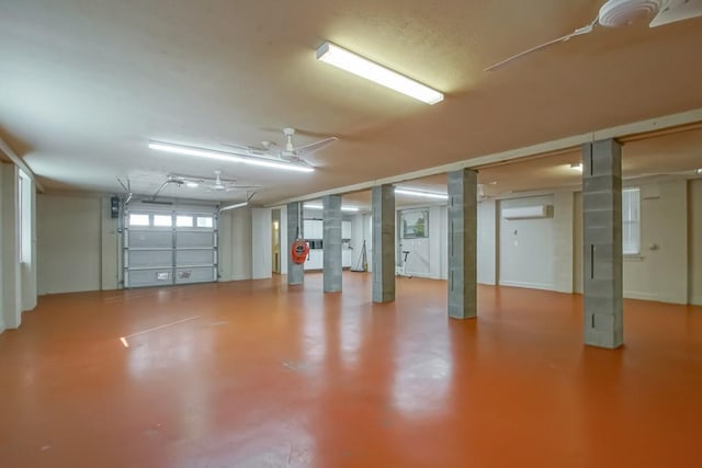 garage featuring an AC wall unit