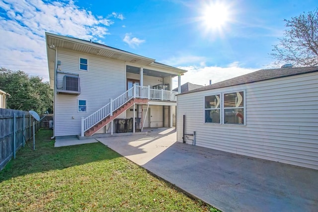 rear view of property featuring a patio area and a yard