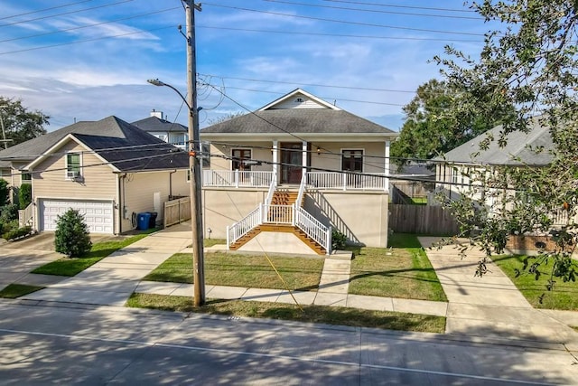 bungalow-style home with a porch, a garage, and a front lawn