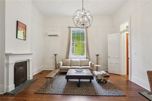 living room with a chandelier, wood-type flooring, and a wall mounted air conditioner