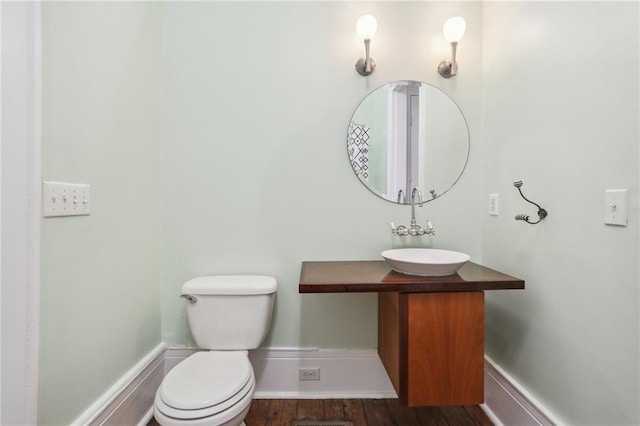 bathroom featuring hardwood / wood-style flooring, vanity, and toilet