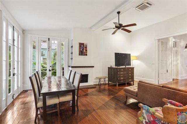 dining room with vaulted ceiling with beams, ceiling fan, french doors, and dark hardwood / wood-style flooring