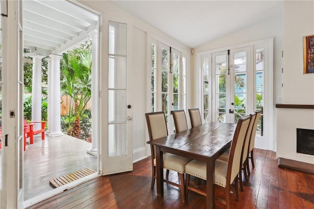 sunroom / solarium featuring french doors and vaulted ceiling