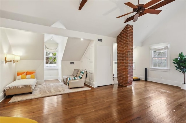 living area with wood-type flooring, plenty of natural light, and lofted ceiling