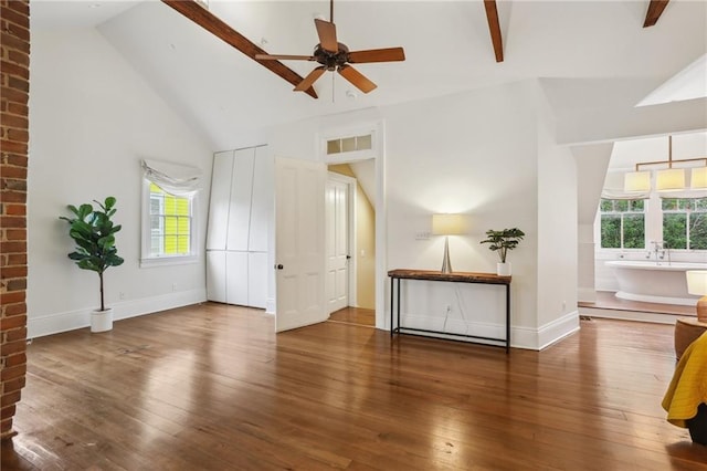 interior space featuring a wealth of natural light, high vaulted ceiling, and hardwood / wood-style flooring