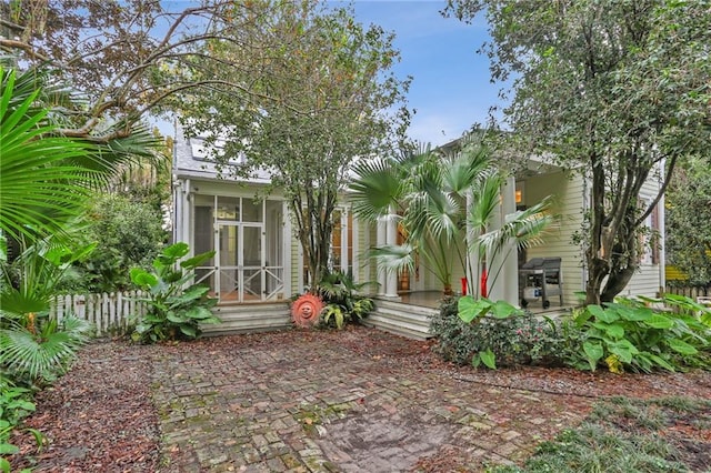 rear view of property with a sunroom