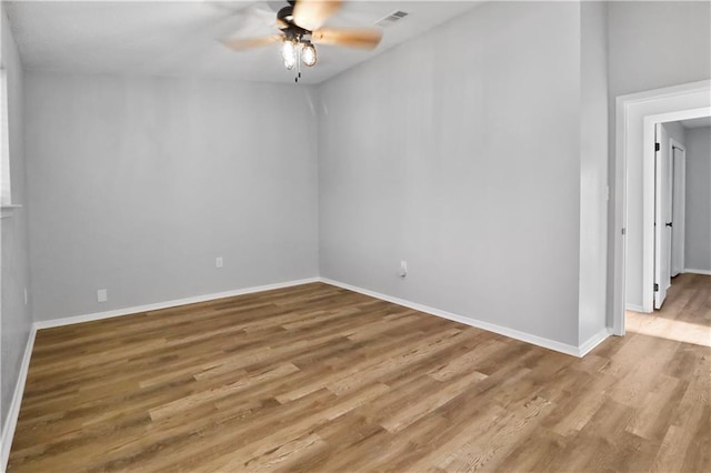 empty room with ceiling fan and light wood-type flooring